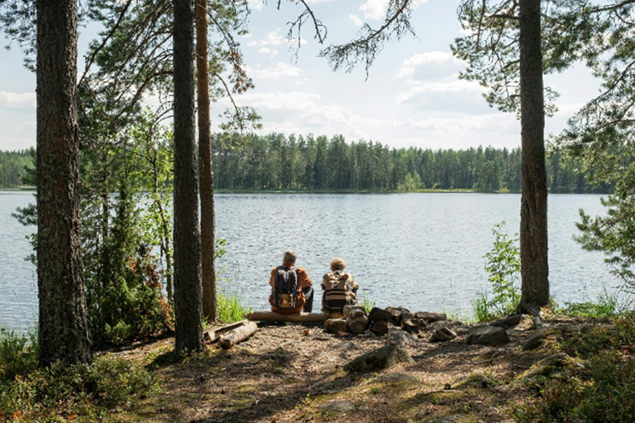 People facing a lake 