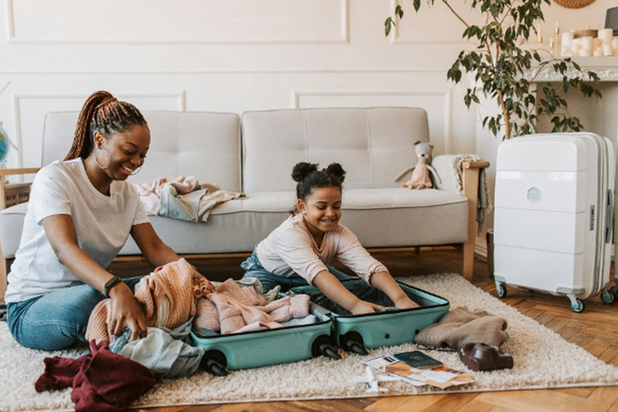 Mother and child putting away luggage 